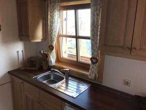 a kitchen counter with a sink and a window at Lärchenhütte in Jadersdorf +7 photos