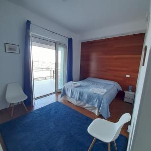 a bedroom with a bed and a large window at L'Attico di Matilde in Syracuse