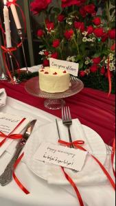 a table with a cake and a plate with a fork and knife at مجمع مهنا in Tabuk