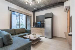 a living room with a couch and a table and a refrigerator at Amine Apart-Hotel by Stayinn in Beirut