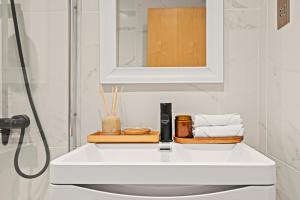 a bathroom with a white sink and a mirror at Kensington Prime Apartments in London