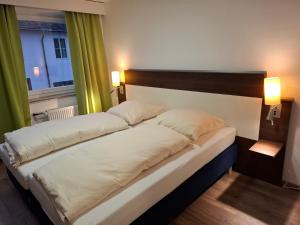 Postel nebo postele na pokoji v ubytování Hotel Zens