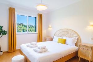 En eller flere senge i et værelse på GuestReady - A sweet escape in Caniço