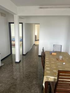 a dining room with a table and chairs at Coconut House in Albion