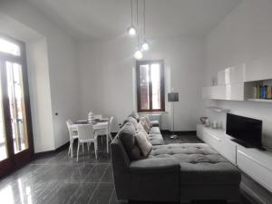 a living room with a couch and a table at Villa Santoni Guest House Orte Home Sweet Home Viterbo in Orte