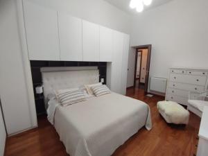 a bedroom with a white bed and a sink at Villa Santoni Guest House Orte Home Sweet Home Viterbo in Orte