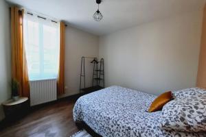 a bedroom with a bed and a large window at Escapade à Éguzon Maison 3 chambres in Éguzon-Chantôme