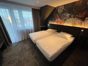 Ένα ή περισσότερα κρεβάτια σε δωμάτιο στο Hotel Elsen
