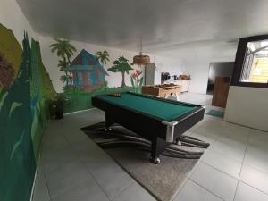 a living room with a pool table in it at kaz'manou in Saint-Benoît