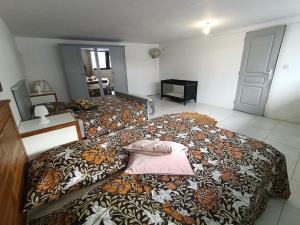 a bedroom with two beds with a pillow on it at kaz'manou in Saint-Benoît
