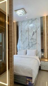 a bedroom with a large bed with a marble headboard at Montage Villa near Beach with Golf View in Nongsa +29 photos