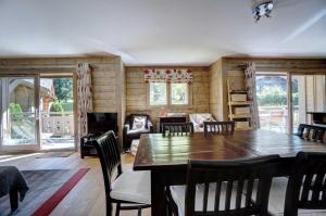 a dining room with a wooden table and chairs at Hameaux du glaciers in Les Houches +7 photos