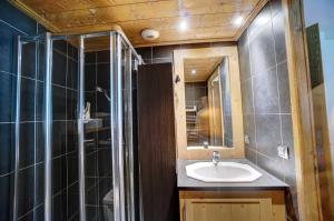 a bathroom with a sink and a shower at Hameaux du glaciers in Les Houches