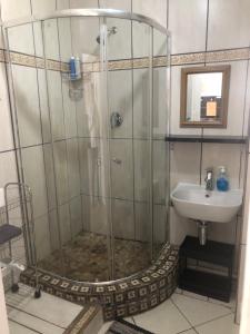 a bathroom with a shower and a sink at Relaxing Hideaway in Strand +23 photos