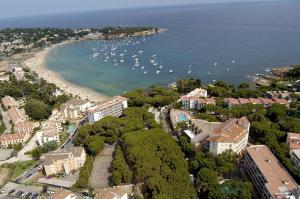 
a large body of water with houses and boats at GHT S'Agaró Mar Hotel in Sant Feliu de Guíxols
