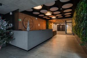 a lobby with a christmas tree and a reception desk at APT Nadmorskie - GreenPort z basenem i strefą SPA in Kołobrzeg