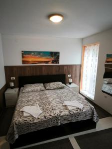 a bedroom with a bed with two towels on it at Apartment Karega in Šibenik