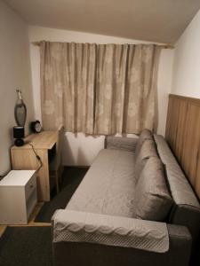 a small bedroom with a bed and a window at Apartment Karega in Šibenik +17 photos