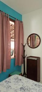 a room with a table and a mirror and a window at Casa de Lorna 2 in Rio de Janeiro