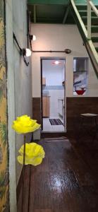 a room with yellow umbrellas on a wooden floor at Casa de Lorna 2 in Rio de Janeiro