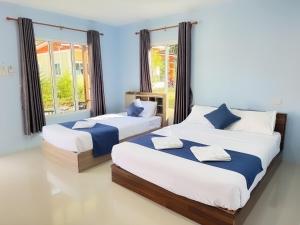 Ένα ή περισσότερα κρεβάτια σε δωμάτιο στο Koh Yao unnrak Resort