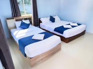 Ένα ή περισσότερα κρεβάτια σε δωμάτιο στο Koh Yao unnrak Resort