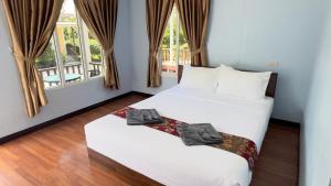 Ένα ή περισσότερα κρεβάτια σε δωμάτιο στο Koh Yao unnrak Resort