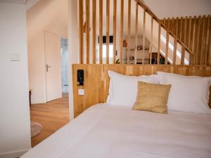 a bedroom with a large bed with white pillows at Baie Marine in Le Crotoy