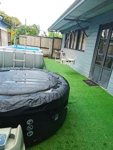 a backyard with a trampoline and a pool at kaz'manou in Saint-Benoît
