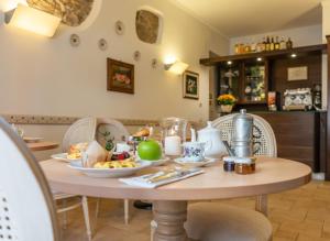 a table with plates of food on top of it at Hotel Il Tiglio in Castel di Sangro