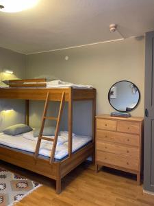 a bunk bed with a mirror and a dresser at Gästhuset i Åre in Åre