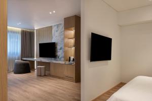a hotel room with a bed and a television at Nur City Suites in Athens +16 photos