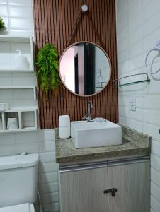 a bathroom with a sink and a mirror at Flat 402 Centro Porto Galinhas in Porto De Galinhas