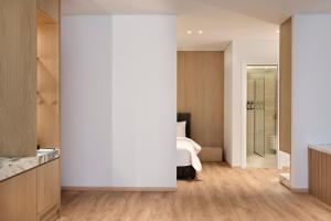a bedroom with a bed and a bathroom at Nur City Suites in Athens