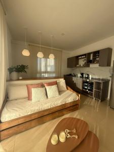 a living room with a couch and a kitchen at Capibara 6 - Vistas de Junin in Corrientes +16 photos