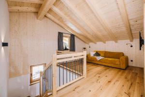 a living room with a staircase and a couch at Moidi's Chalet Spieljoch in Fügenberg