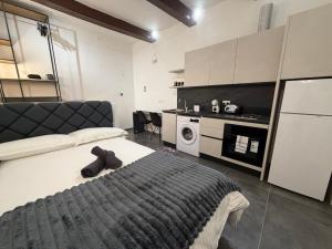 a bedroom with a large bed and a kitchen at 3 St Anne's Street in Valletta