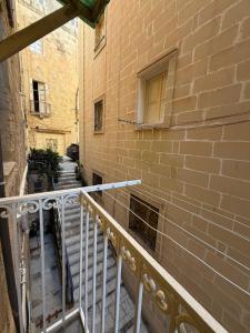 a staircase leading to a brick building with a window at 3 St Anne's Street in Valletta +7 photos