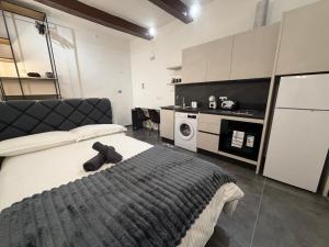 a bedroom with a large bed and a kitchen at 3 St Anne's Street in Valletta