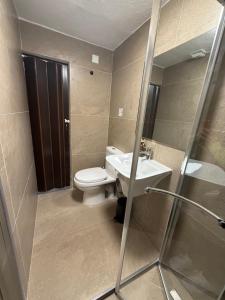 a bathroom with a toilet and a sink and a shower at 3 St Anne's Street in Valletta