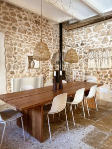 a dining room with a wooden table and chairs at Alphea1570 in Lloseta +5 photos