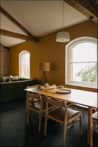 a living room with a table and chairs and a couch at Gibson Mill Penthouse with private balcony - 301 in Hobart