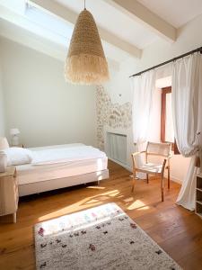 a bedroom with a bed and a chair and a rug at Alphea1570 in Lloseta