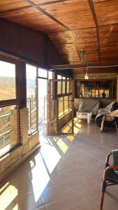 Una habitación grande con ventanas y un sofá en una casa. en Auberge panorama, en Kasba des Aït Athmane