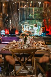 a wooden table with glasses and flowers on it at Matsi Maria Big in Matsi