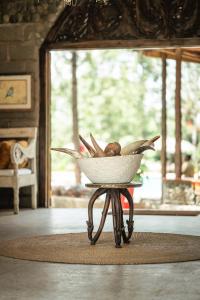 a basket on a stand on a table in a room at Mtoni River Lodge in Arusha