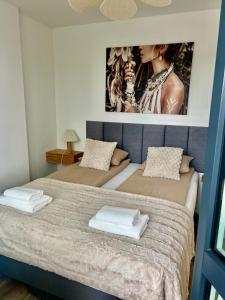 a bedroom with two beds and a picture on the wall at SPV Rentals Pileckiego 59 lokal 258 free Parking Ursynów in Warsaw