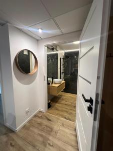 a bathroom with a sink and a mirror at SPV Rentals Pileckiego 59 lokal 258 free Parking Ursynów in Warsaw +17 photos