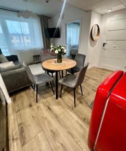 a living room with a table and chairs and a couch at SPV Rentals Pileckiego 59 lokal 258 free Parking Ursynów in Warsaw