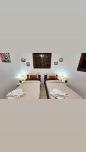 a room with three beds in a room at Vi la dous Kreyol in Sainte-Rose